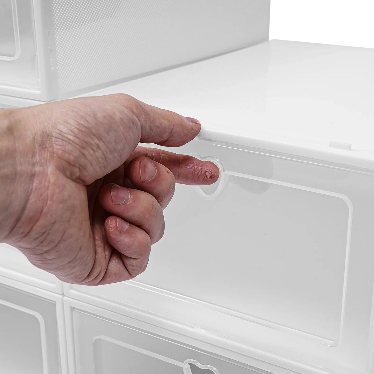 Stackable transparent shoe storage boxes organized with shoes inside